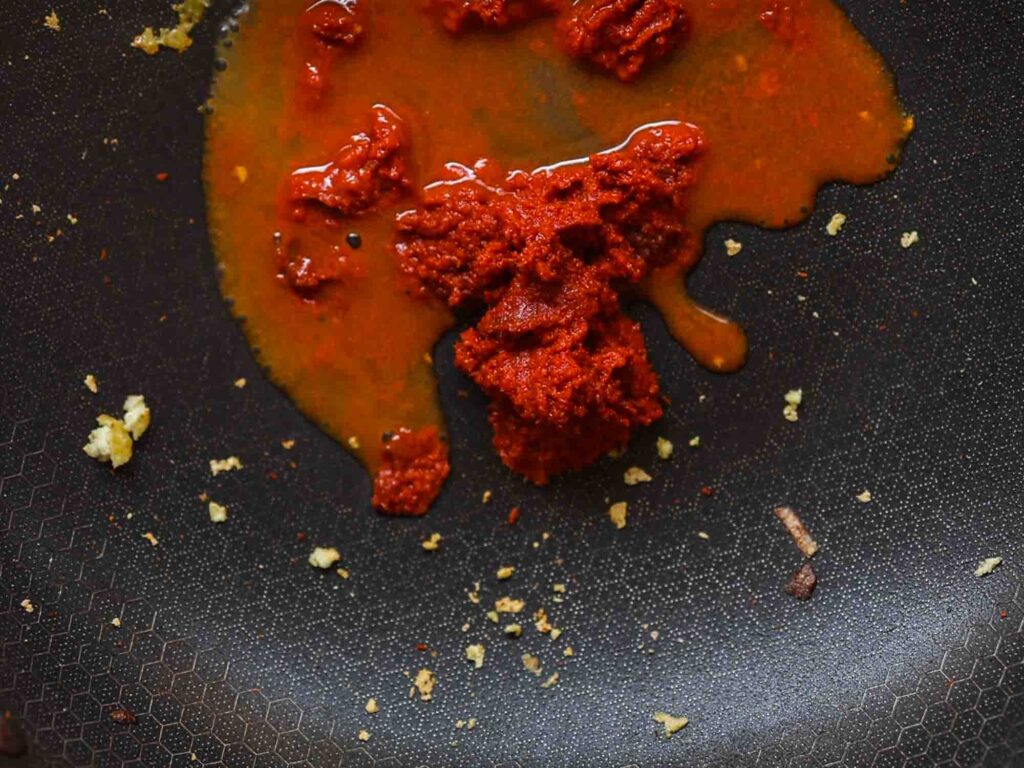 red curry paste cooking in veggie broth